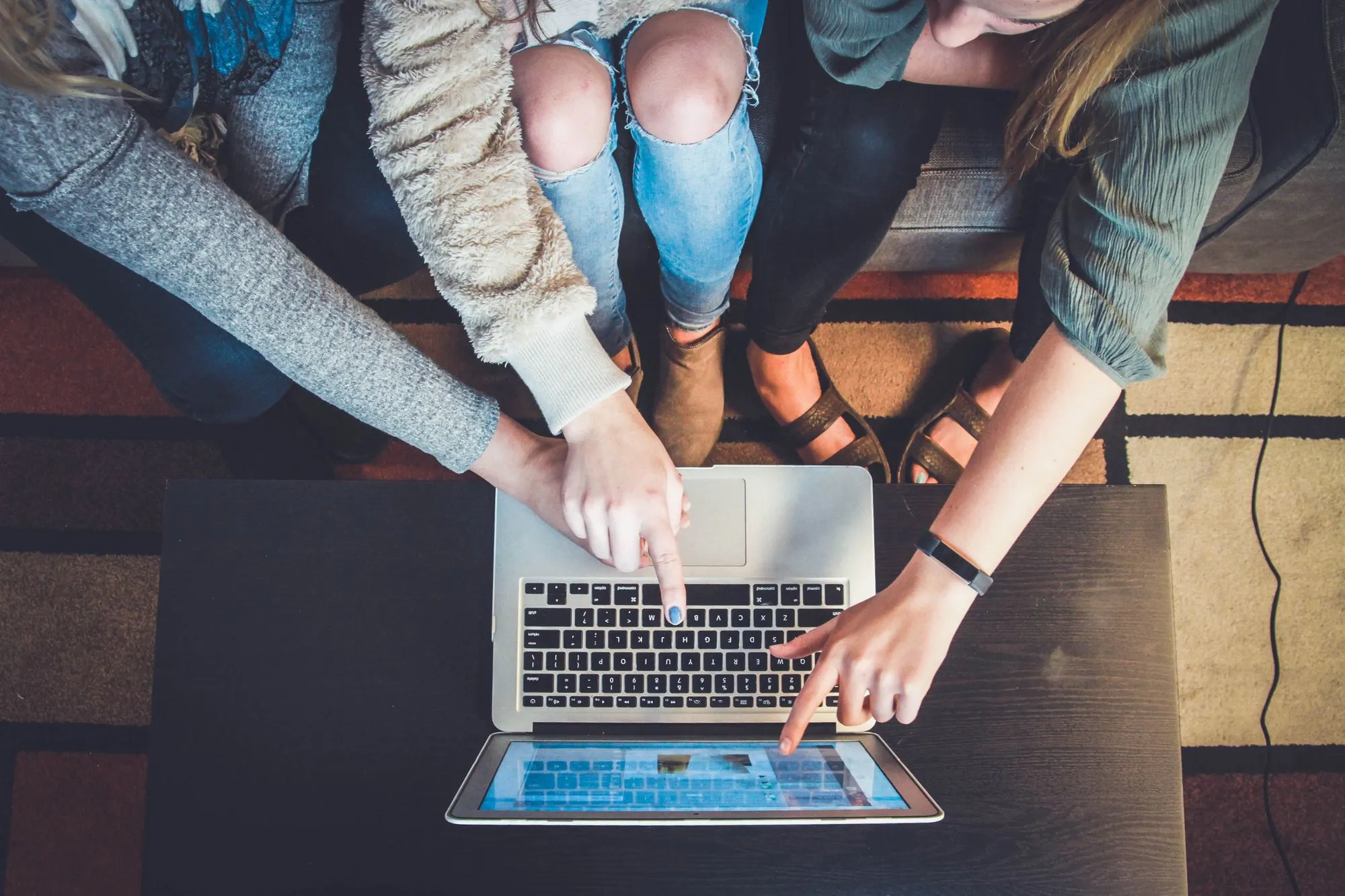 Group of people interacting with a computer screen